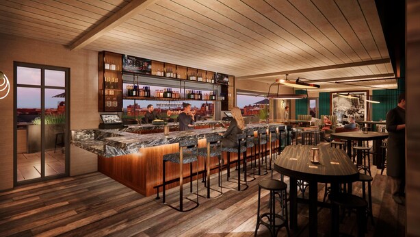 A modern bar area with a wooden ceiling, a bar counter with stools, and a cityscape view through the window.