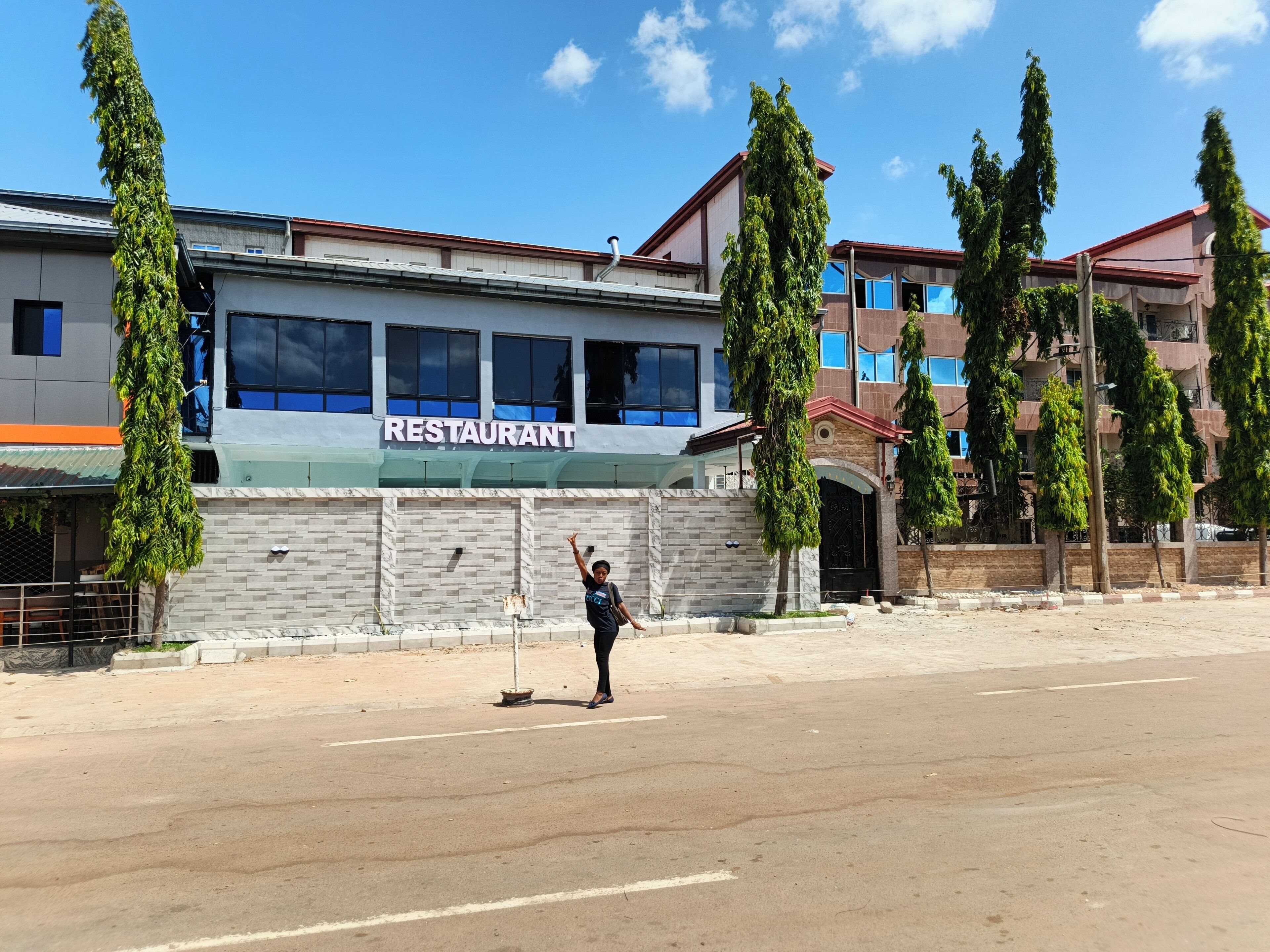A building with a sign that reads 'RESTAURANT' on the facade.