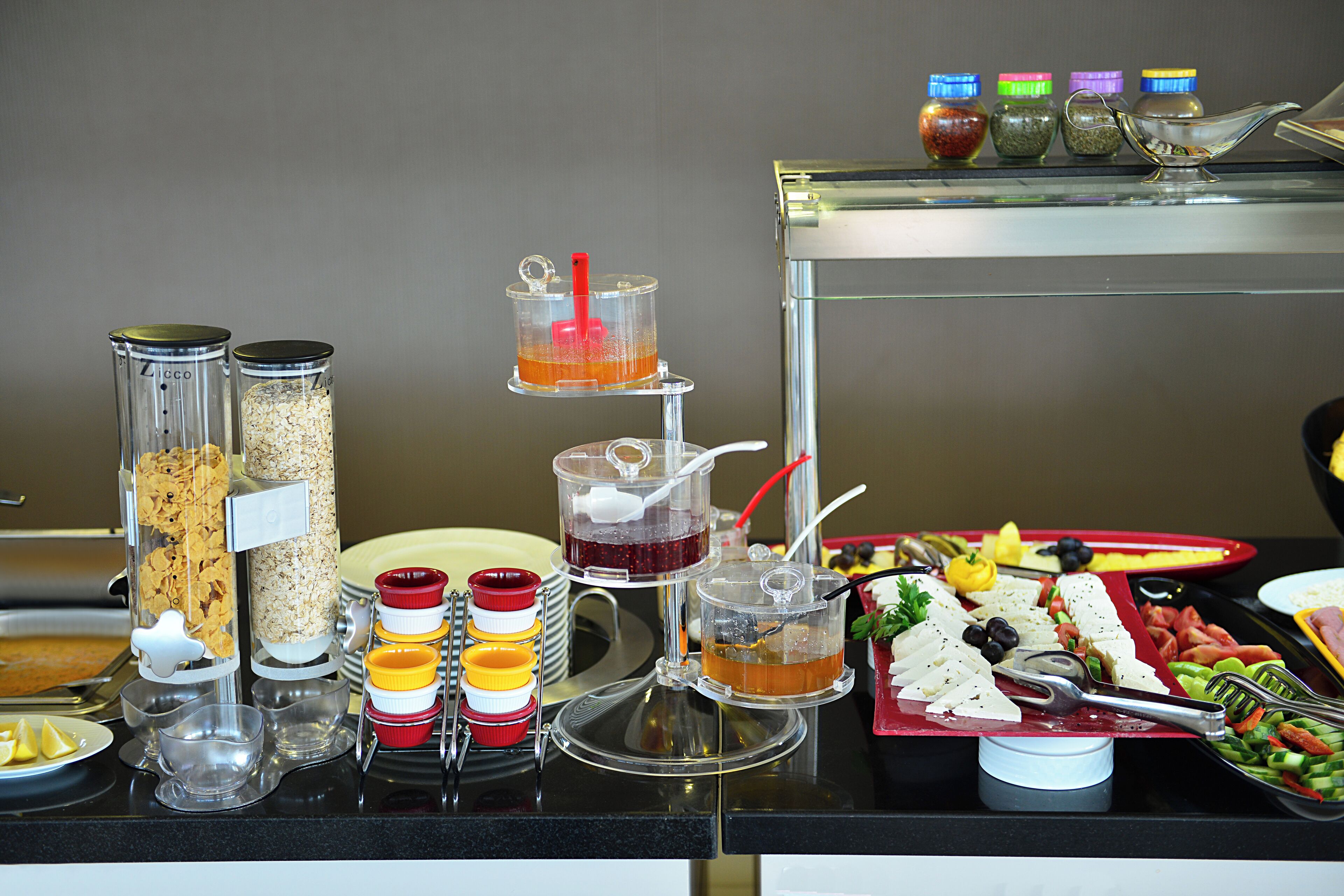 A buffet with various food items and condiments.