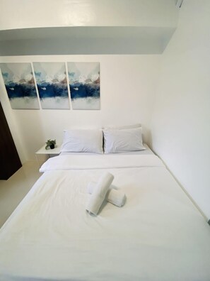 Tabla de planchar con plancha y ropa de cama