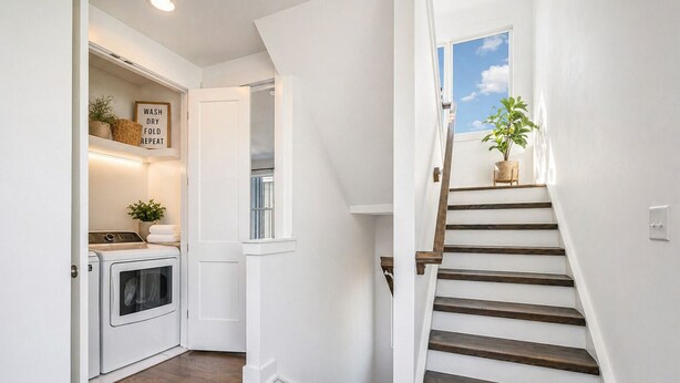 A laundry room with a washing machine, a drying rack, and a sign with laundry instructions. - Madmen Loft w/ Uptown Rooftop Views (Charlotte)