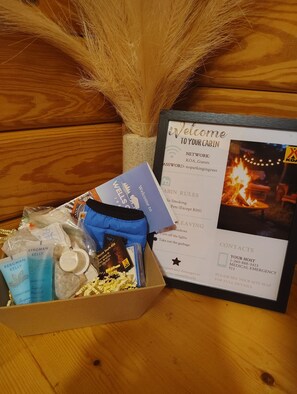 A welcome package with toiletries, a welcome card, and a fire image.