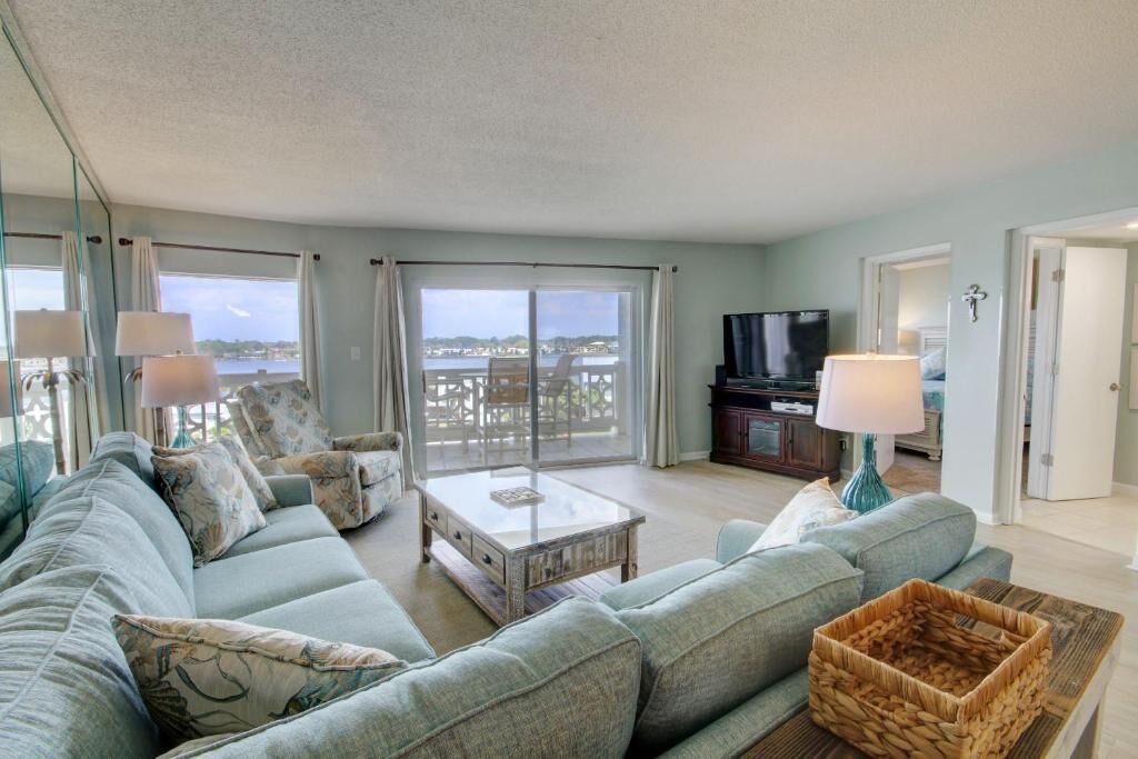 A living room with a sofa, a coffee table, and a television.