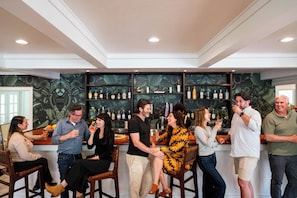 A group of people in a bar area with a high ceiling and recessed lighting. - Mendocino Cove (Fort Bragg)