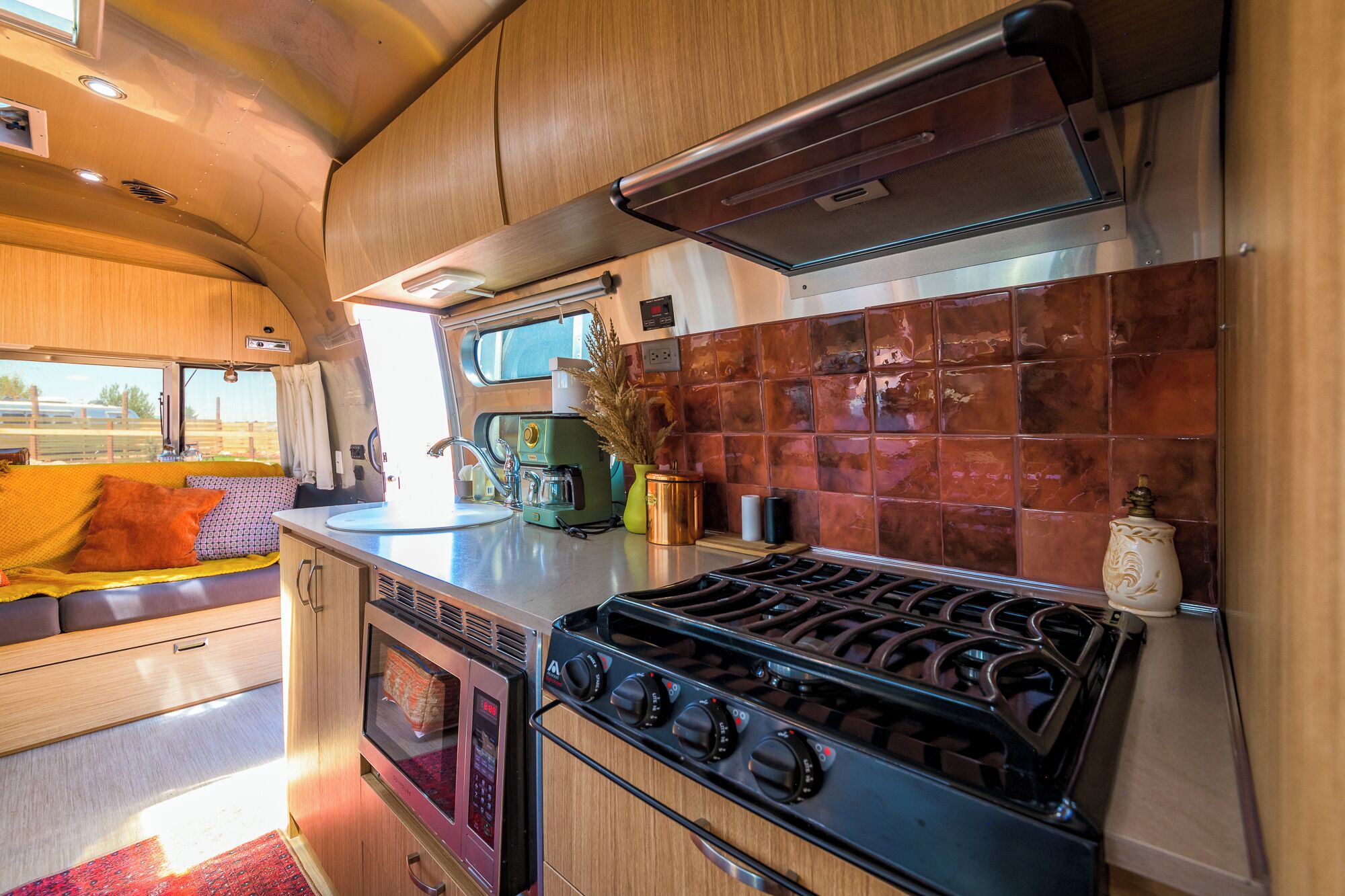 A compact kitchen with a stove, oven, and microwave.