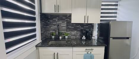 Fridge, microwave, stovetop, coffee/tea maker