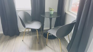 A room with two grey chairs and a small table with a potted plant. - Zen Den Getaway, your peaceful retreat near Cleveland’s vibrant AsiaTown. (Cleveland)