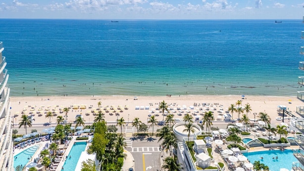 A resort with a beach, pool, and ocean view. - Birch Road Beach House | Oceanfront | Luxury Villa (Fort Lauderdale)