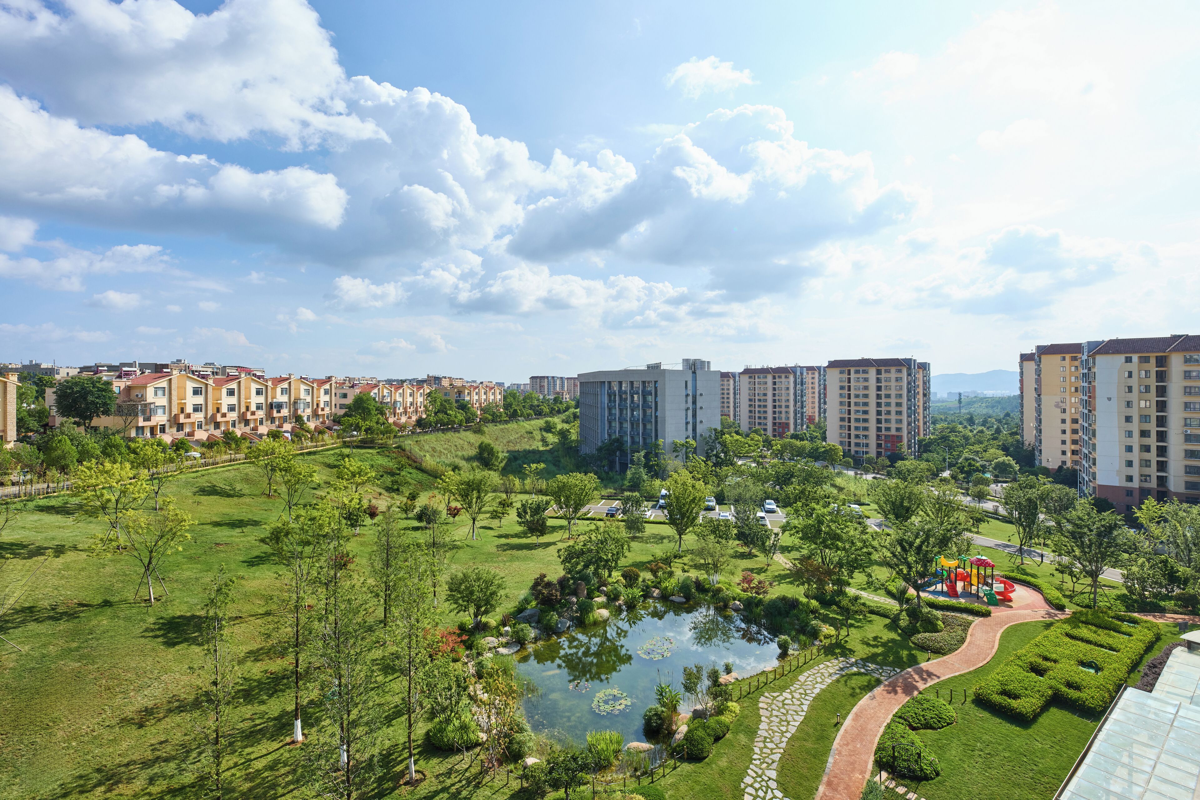 A residential area with a park, a pond, and a playground.