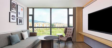 Comfort Suite, 1 King Bed, Garden View | Living room | LCD TV, foosball