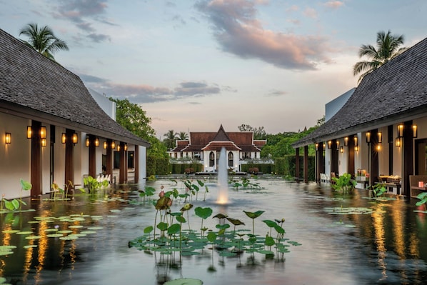 A hotel courtyard with a central fountain, surrounded by water lilies, and two wings with traditional architecture. - Marriott Vacation Club, Khao Lak Beach Resort (Takua Pa)
