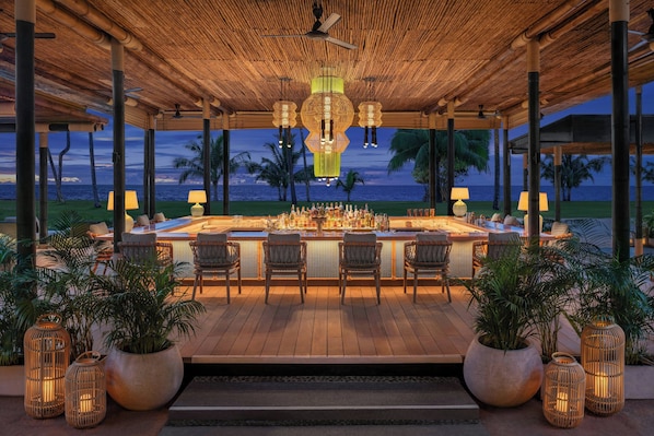 An outdoor bar area with a wooden deck, bar stools, and potted plants. - Marriott Vacation Club, Khao Lak Beach Resort (Takua Pa)