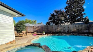 A backyard with a swimming pool, a hot tub, and a wooden deck. - Luxe 4BR with Heated Pool and Hot Tub - Walk to Lake (Grapevine)