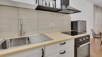 Comfort Apartment | Private kitchen | Cleaning supplies, freezer