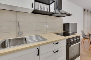 Comfort Apartment | Private kitchen | Cleaning supplies, freezer