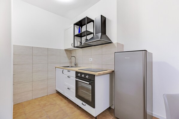 Comfort Apartment | Private kitchen | Cleaning supplies, freezer