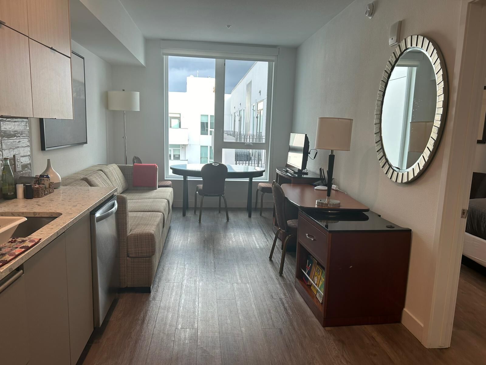 A compact living space with a kitchenette, a dining area, and a workspace.