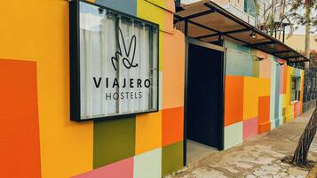 A colorful hostel exterior with a large sign reading 'VIAJERO HOSTELS.'