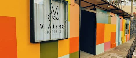 A colorful hostel exterior with a large sign reading 'VIAJERO HOSTELS.'
