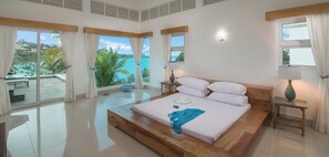 A spacious bedroom with a large bed, a view of the ocean, and a balcony. - Crown Villas at Lifestyle — Villas Only | Mandatory All-Inclusive Paid at Resort  (Puerto Plata)