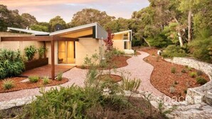 A modern house with a curved driveway, surrounded by landscaped gardens and trees. - Selador- Couples Bush Retreat & Close To Town (Margaret River)