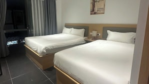 A hotel room with two beds, a window with curtains, a painting on the wall, and a ceiling light. - Starlight Hotel Hanoi (Hanoi)
