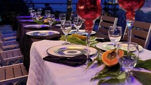A table set for dining with plates, cutlery, and glasses. - Suite 4 Hotel VOS - Superior Suite, Ocean View (Manuel Antonio)