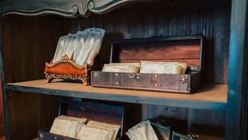 A wooden cabinet with multiple drawers containing old books and papers.