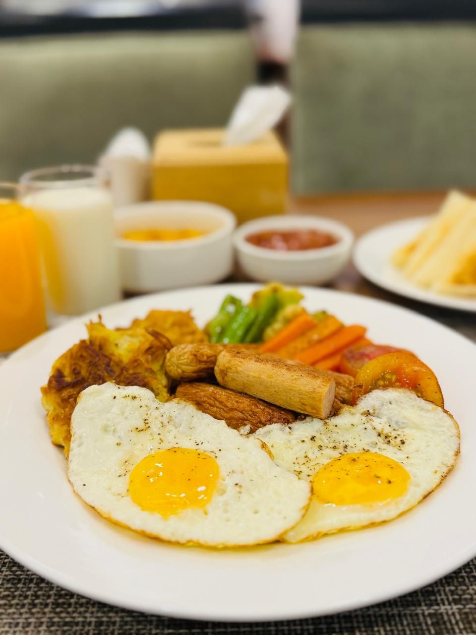 Un plato de desayuno con huevos, patatas ralladas y verduras.