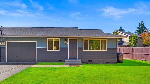 A single-story house with a garage, a front porch, and a well-maintained lawn. - Spacious 2BR Duplex Family Group Friendly (Lynnwood)
