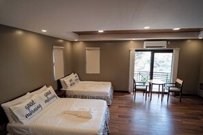 A hotel room with two beds, a balcony, and a small table with chairs. - Villa Minerva Eco-farm Resort Near Vigan By Zuzu (Caoayan)