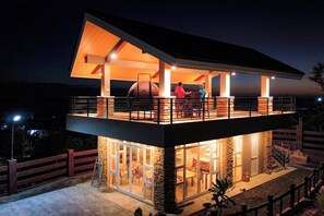 A two-story modern house with a balcony, large windows, and a stone exterior. - Villa Minerva Eco-farm Resort Near Vigan By Zuzu (Caoayan)