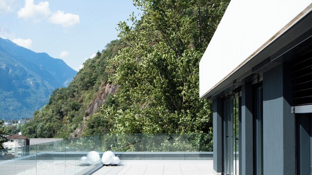 A modern building with a glass balcony overlooking a mountainous landscape. - Arbed Living Hotel Self Check-in (Arbedo-Castione)