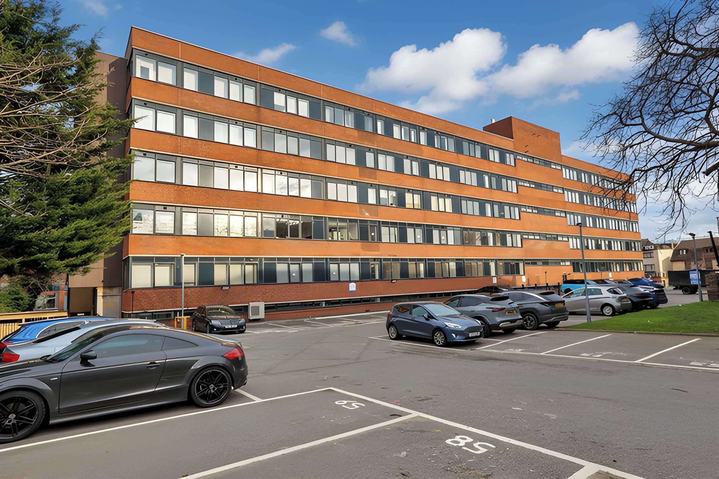 A multi-story parking garage with cars parked in designated spaces.