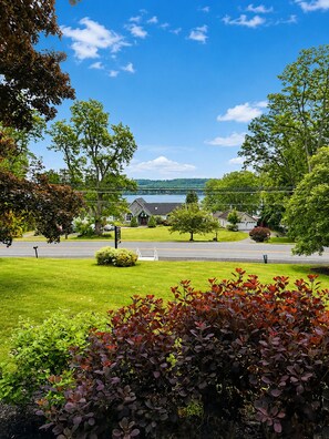 A residential area with a road, houses, and a lake in the background. - The Keuka Cove House - Lakefront + Private Dock - Sleeps 16 (Penn Yan)