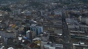 A cityscape with a variety of building types, including residential and commercial structures. - One-bedroom French style apartment in downtown Ambato (Ambato)
