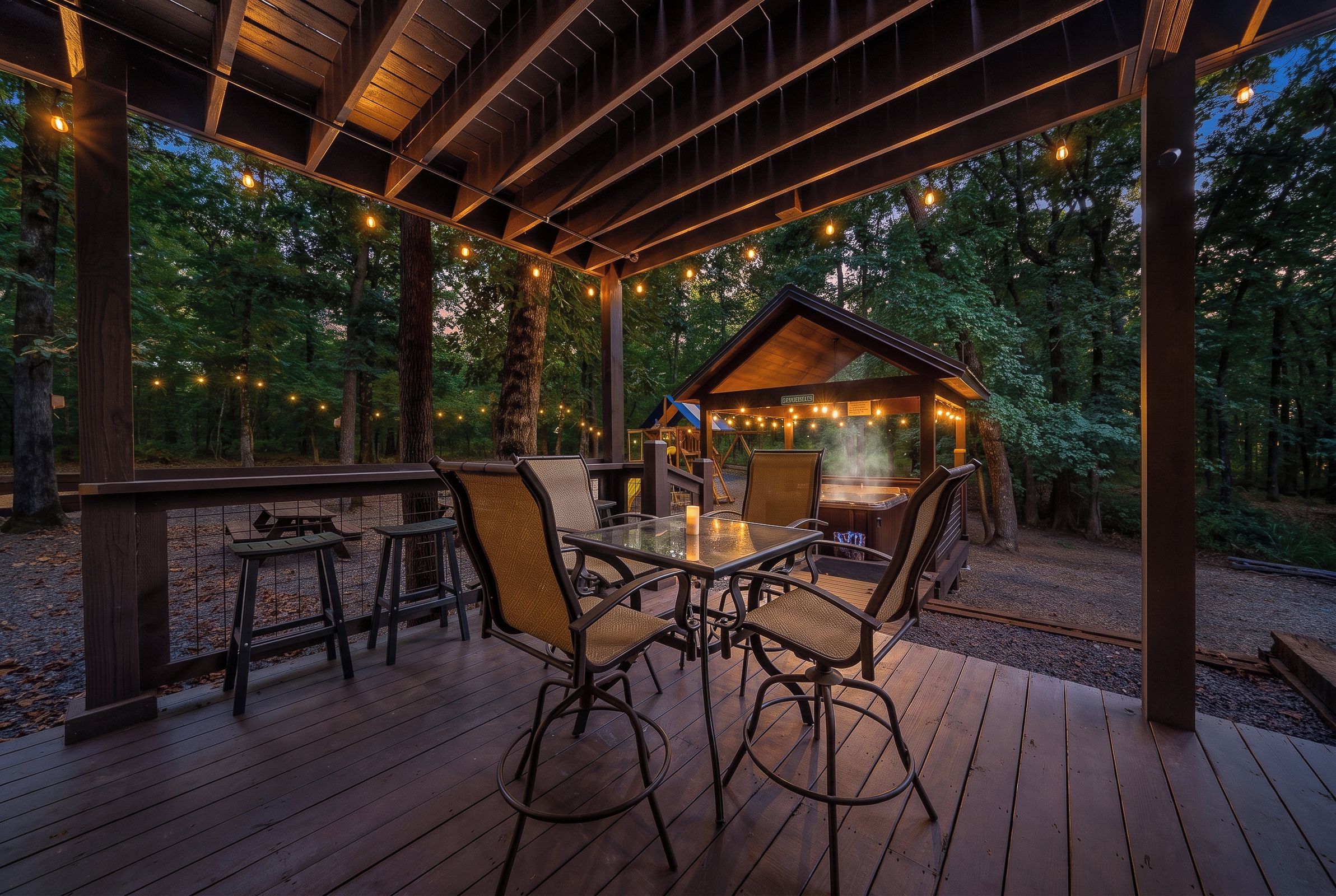 A wooden deck with outdoor seating and a hot tub.