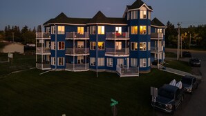 Un edificio de varios pisos con balcones, un garaje y una señal de calle que indica 'Lakeshore Ave'.