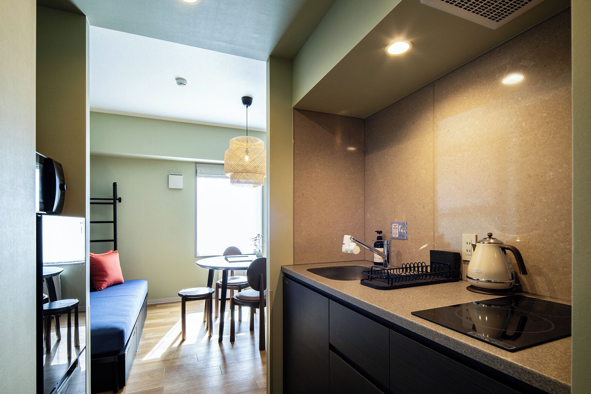 A compact kitchen with a sink, stove, and dining area.