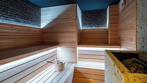 A sauna with wooden benches and a stone wall. - Section L Ueno-Hirokoji (Tokyo)