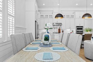 A modern kitchen with white cabinets, a stainless steel range hood, and a built-in oven. - Sleeps 20 | 2 Homes, 9BDR, Arcade | Walk to Blue Mountain Beach Access & Eats (Santa Rosa Beach)