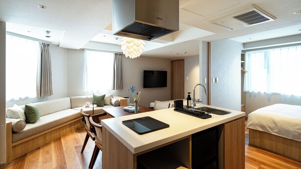 A modern hotel room with a kitchenette, a sofa, a dining area, and a bed. - Section L Shimbashi West (Tokyo)