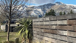A wooden fence with a mountain backdrop.