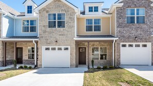 A row of three townhouses with attached garages, each with a distinct exterior style. - 1 King 2 Queens Garage Yard Washer Dryer (Old Hickory)