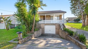A two-story house with a covered porch and a garage. - 12 Borang @ The Point (Potato Point)