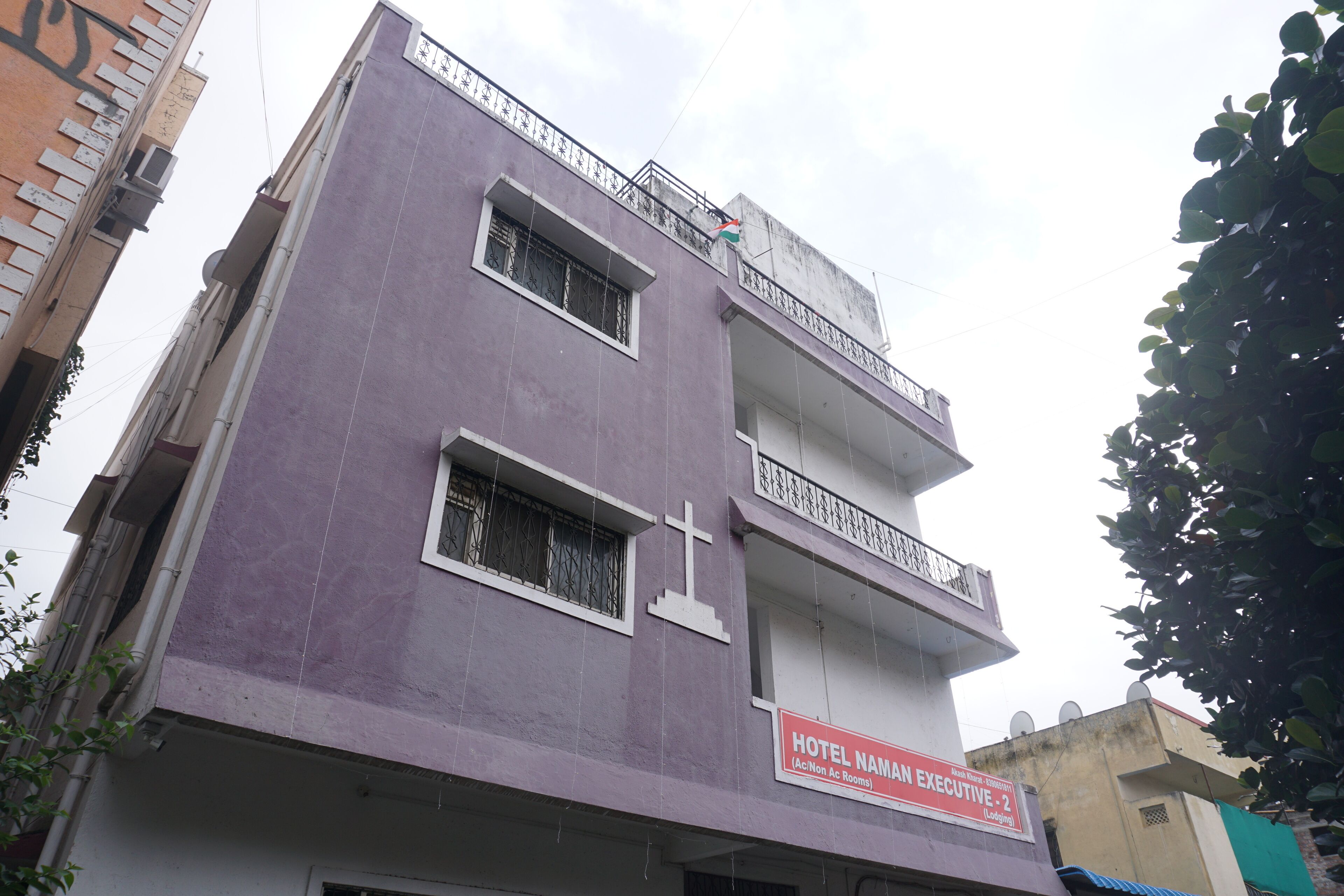 A multi-story building with a sign indicating it is a hotel named "Hotel Namam Executive - 2."