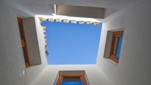 A skylight with a clear blue sky view, a small window, and a wooden door frame. - Casa Paraiso by Marhen Homes (Javea / Xàbia)