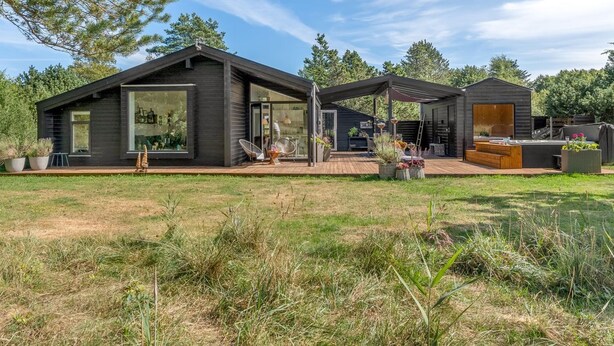 A modern house with a large deck, a covered outdoor seating area, and a small shed. - "Eilke" - 2km from the sea by Interhome (Ålbæk)