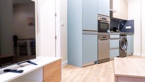A modern kitchen with a built-in oven, microwave, and dishwasher. - Apartamentos Doña Berenguela by gaiarooms (León)