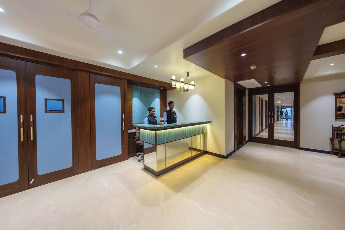 A reception area with a counter, wooden cabinets, and a modern ceiling design.